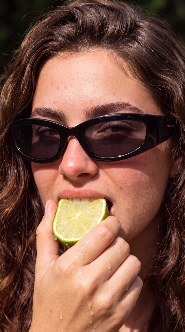 AI-generated still: black sunglasses, a slice of lime